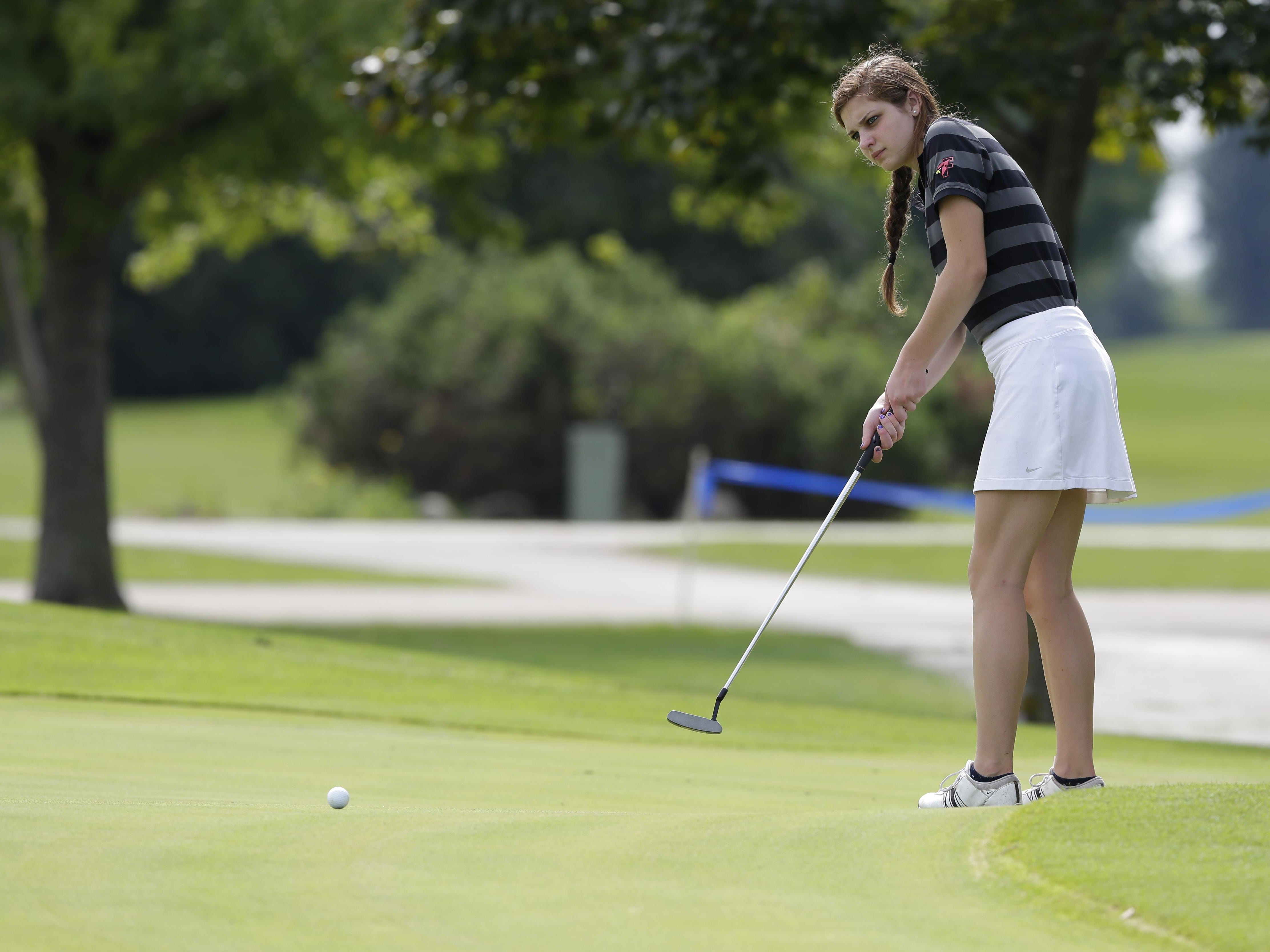 Fond du Lac's Sydney George attempts a long putt during the FVA conference golf meet held at Lake Breeze Golf Course in Winneconne.