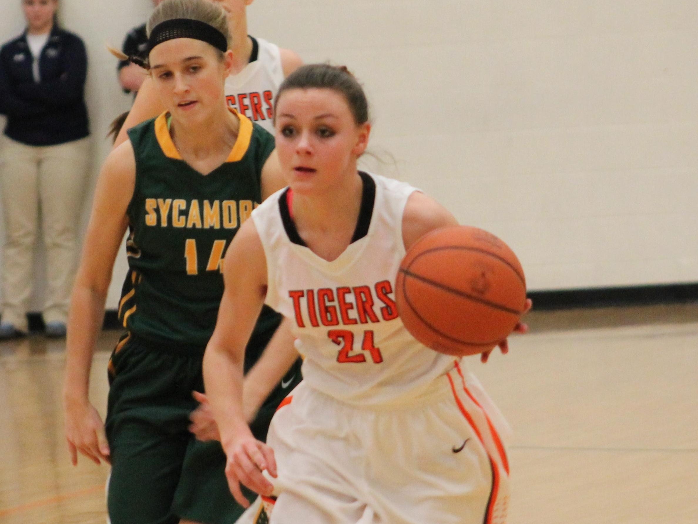 Sycamore’s Kelsey Kandil chases Colleen Swift of Loveland last February.