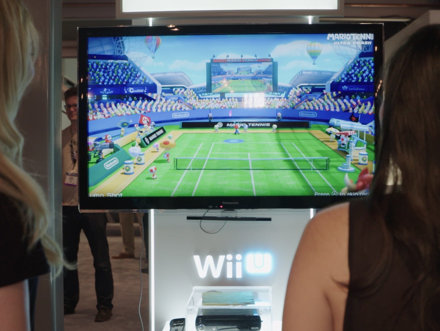 Women at E3 2015 play games on the Nintendo Wii U.