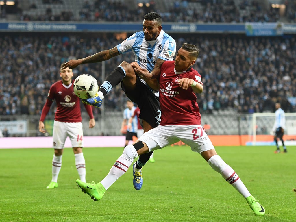 Amilton, left, of TSV 1860 Muenchen challenges Abdelhamid Sabiri of 1. FC Nuernberg during the Second Bundesliga match between TSV 1860 Muenchen and 1. FC Nuernberg at Allianz Arena in Munich, Germany.