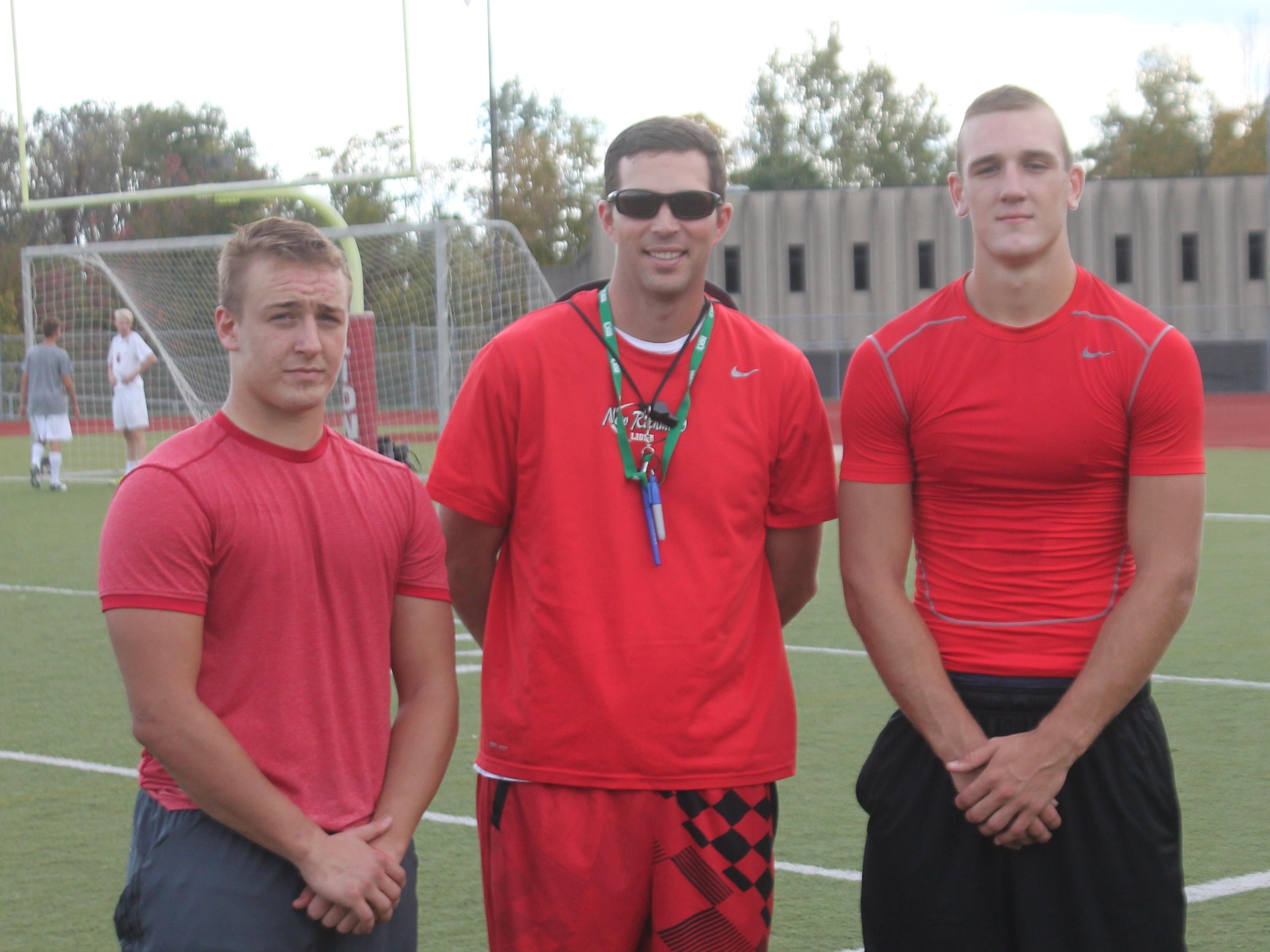 New Richmond again finds itself in the running for the playoffs. From left are senior running back Michael Williamson, head coach Josh Stratton and senior quarterback Austin Torrens.