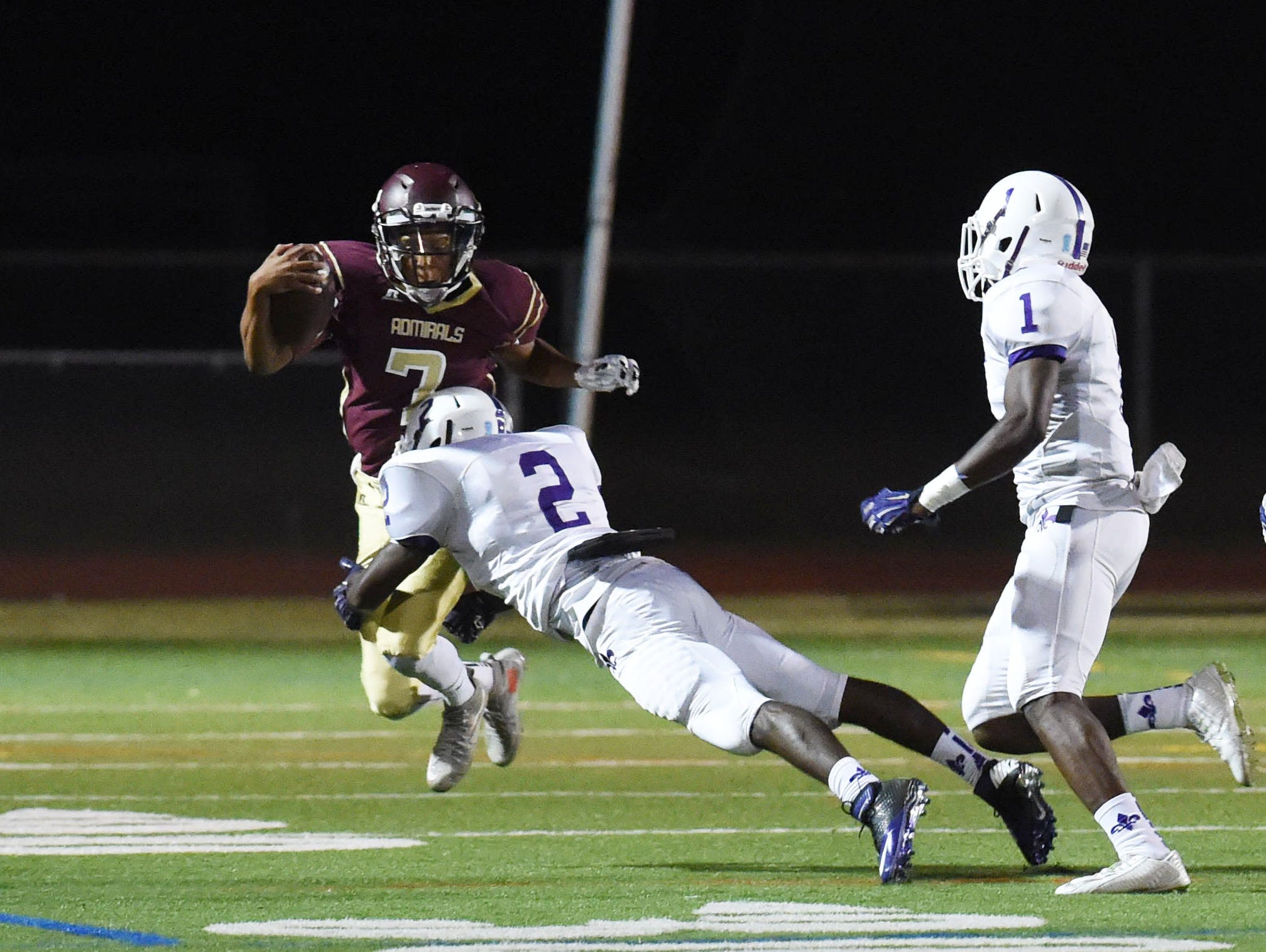 Arlington's Justin Leigh tries to jump out of the way of New Rochelle's Manny Walker during Friday's game.