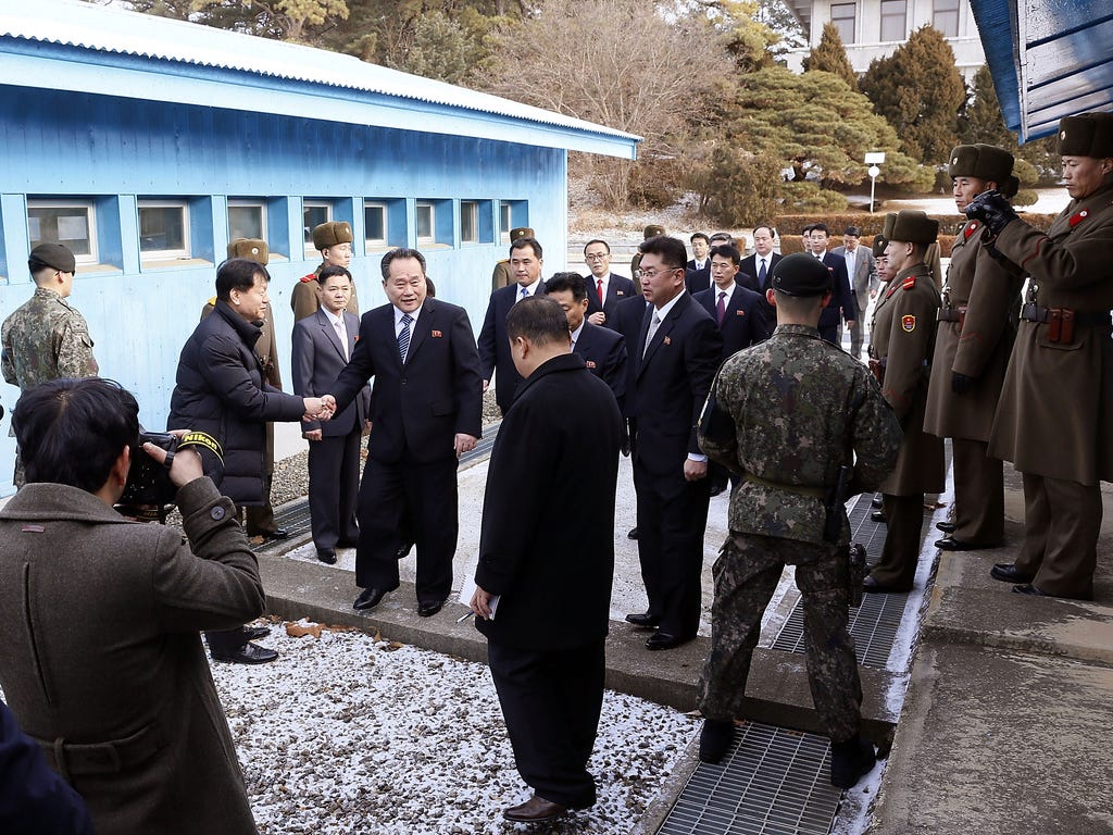The head of the North Korean delegation Ri Son-Gwon (C) crosses a border line to attend their meeting at Panmunjom in the Demilitarized Zone on Jan. 9, 2018 in Panmunjom, South Korea. South and North Korea begin their first official face-to-face talk