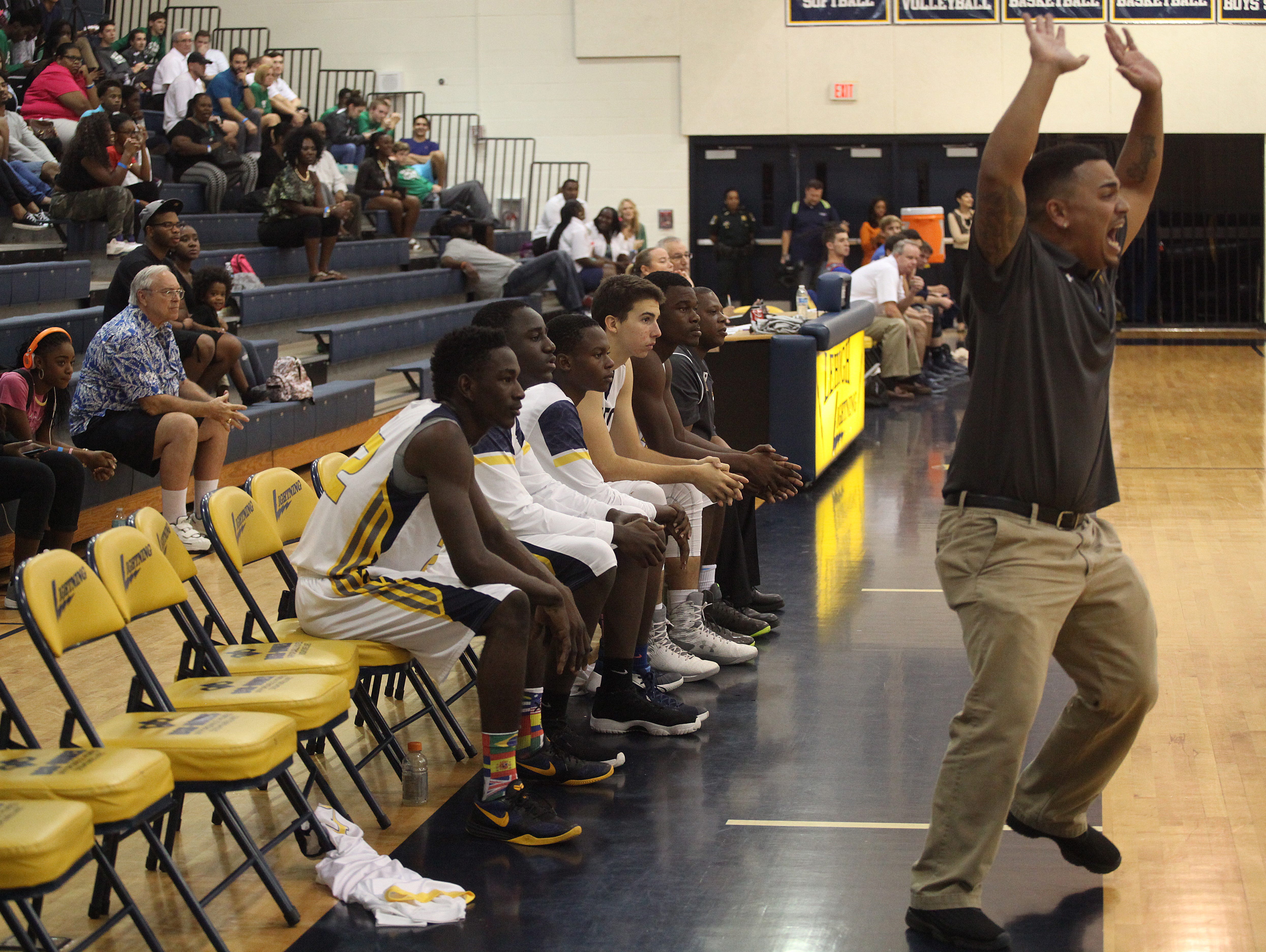 Lehigh basketball coach Mike Bonilla communicates with his team from the sidelines during a game against Estero on Wednesday. Bonilla was filling in for coach Dawn McNew who was suspended. Empty seats on Lehigh’s bench are the result of the suspension of several players.