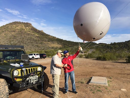 Anglin shows reporter Joe Dana how his balloon surveillance