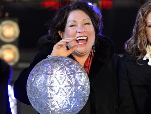 Supreme Court Justice Sonia Maria Sotomayor presses the countdown ball as thousands of revelers gather in New York's Times Square.