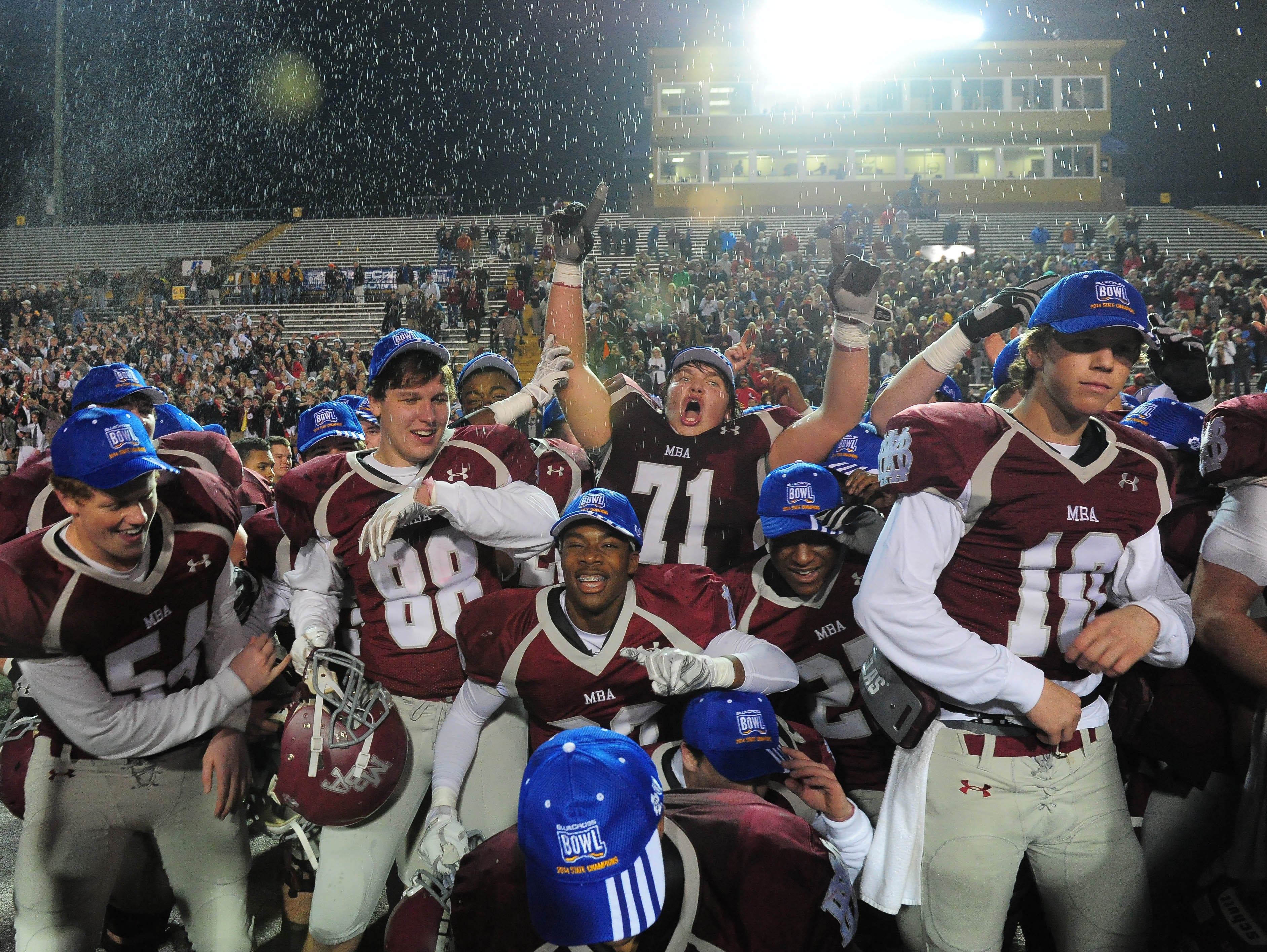 Montgomery Bell Academy players celebrate their 10-7 win over Ensworth for the Division II-AA state championship last December..