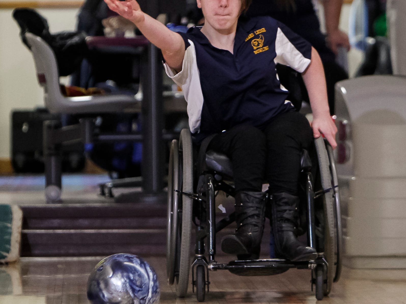 Grand Ledge Bowling team member, sophomore Caitlyn Wells sends the ball down the lane at Royal Scott Tuesday. Wells has spina bifida, and has been in a wheelchair her entire life.