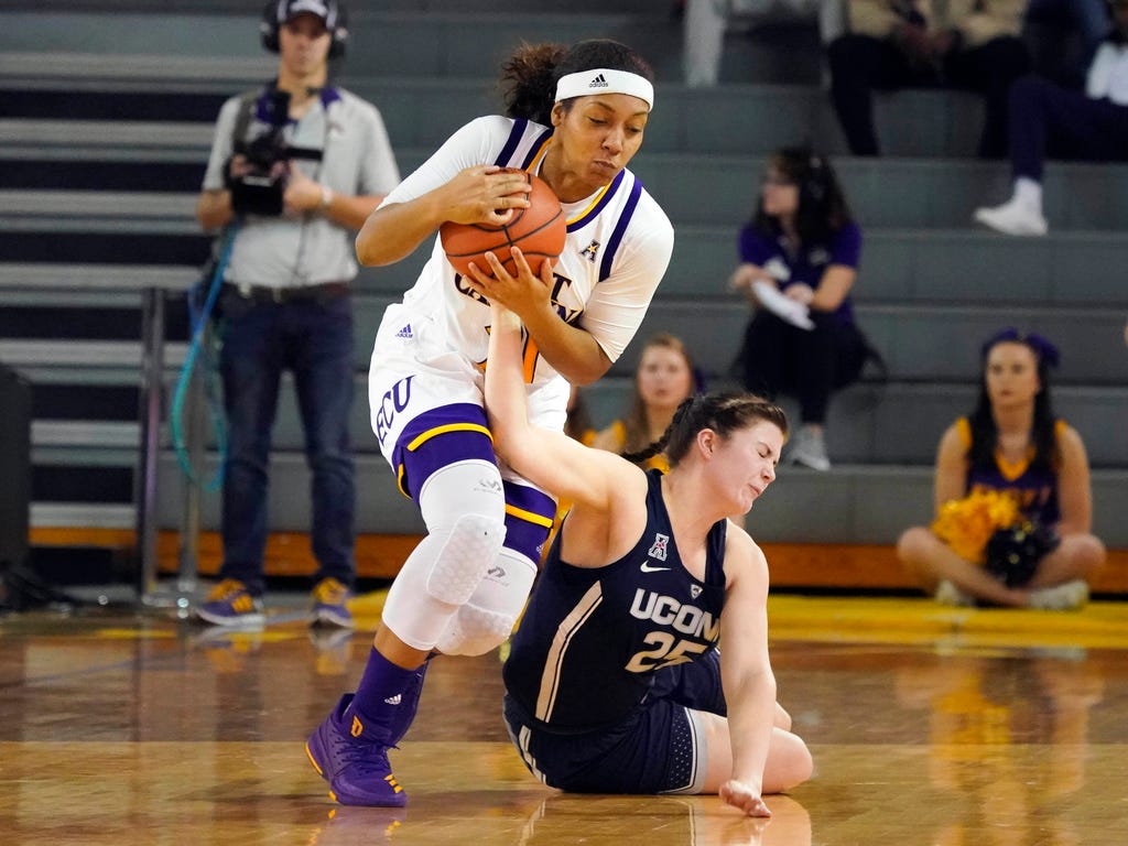 Connecticut Huskies forward Kyla Irwin goes after the ball against East Carolina Pirates forward Salita Greene during the second half at Minges Coliseum in Greenville, N.C. The Connecticut Huskies defeated the East Carolina Pirates 96-35.