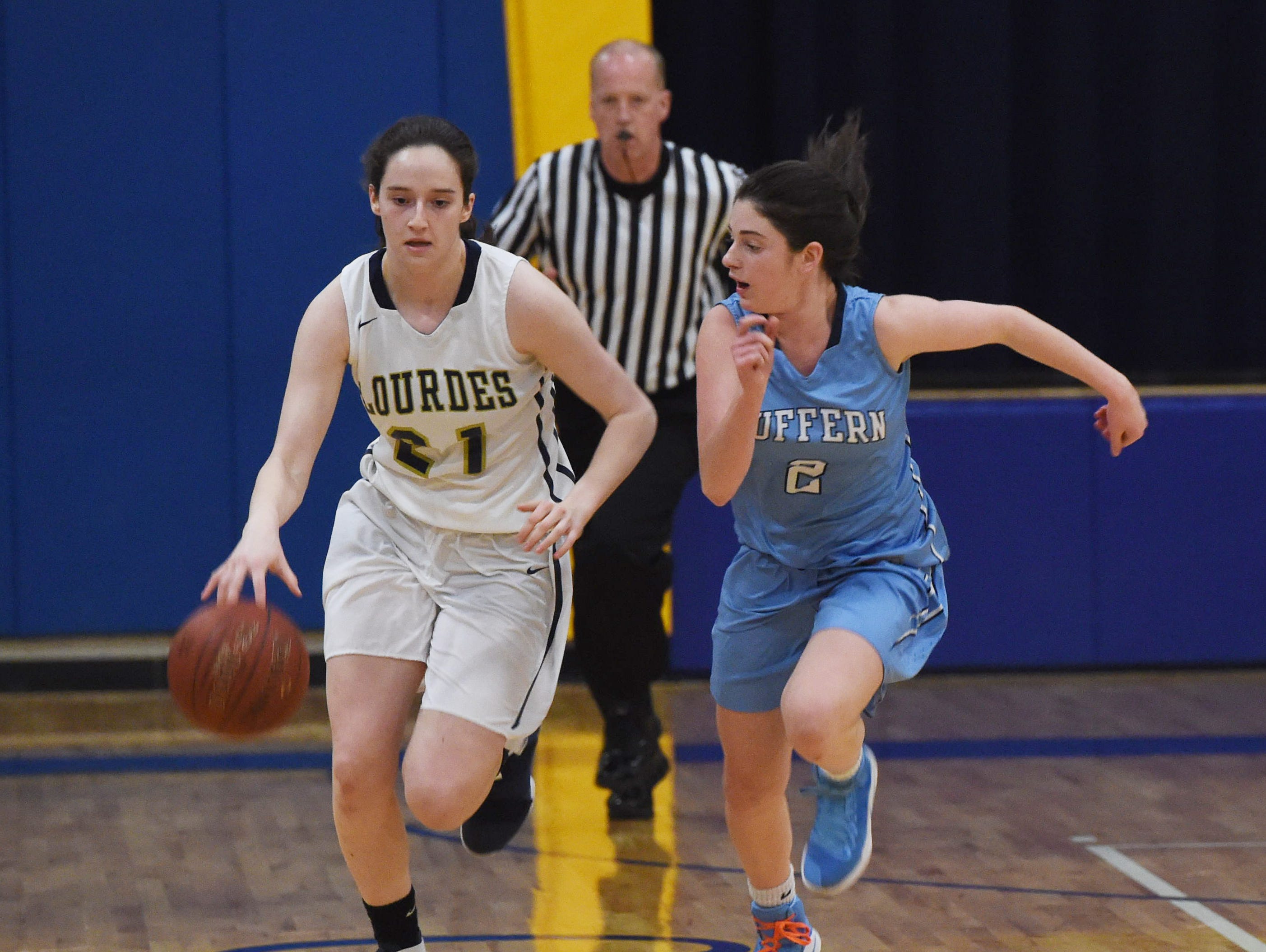Lourdes' Daniela Valdez, left, takes the ball down the court as Suffern's Allie Goldstein, right, defends during Friday's game.