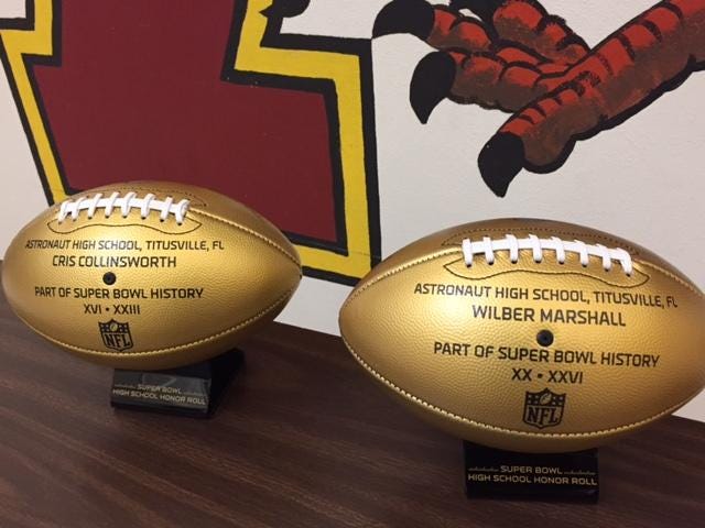 Astronaut High displays two golden Wilson footballs sent by the NFL to commemorate former War Eagles who played in Super Bowls, Cris Collinsworth and Wilber Marshall.