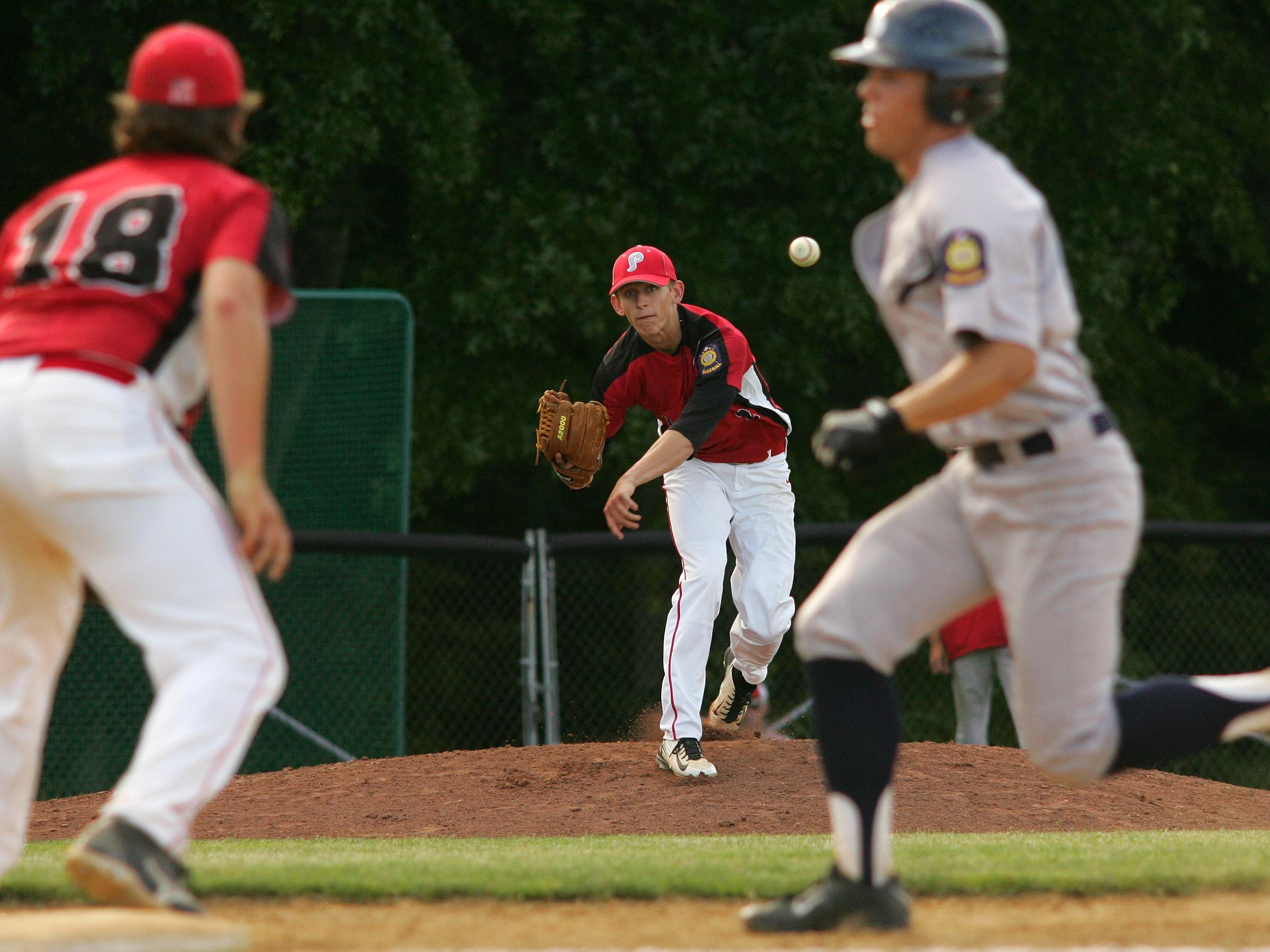 Pickerington Post 283 pitcher Cole Music makes a pickoff throw to teammate Doug Connor June 24 during the team’s 12-2 victory against Lancaster Post 11. Music and Connor are two of four Watkins Memorial players on the team.