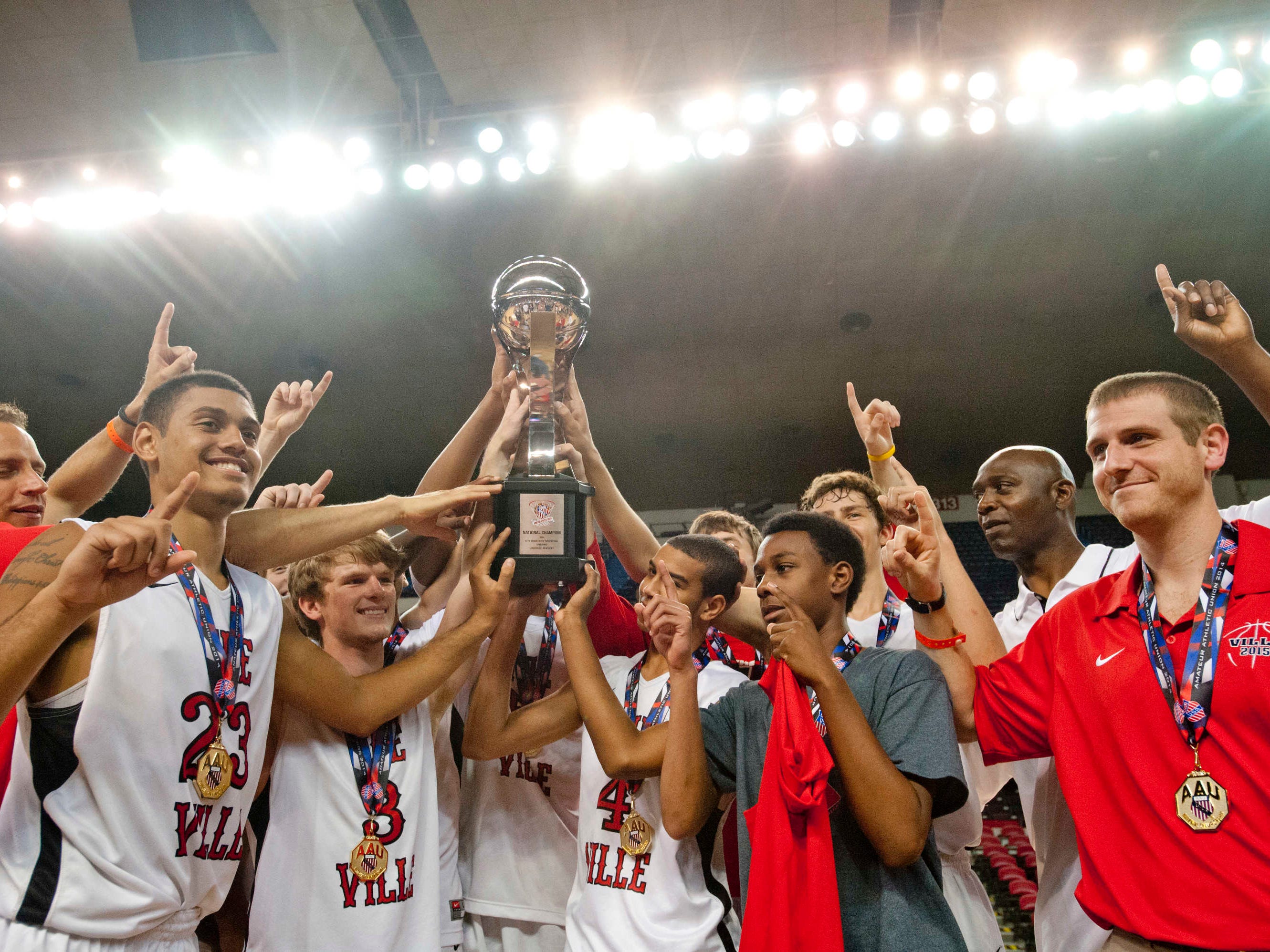 The Ville celebrates its 11th-grade AAU national championship in Freedom Hall on Monday night. Trinity High big man Raymond Spalding scored 15 points in The Ville’s 46-40 victory over the Albany (N.Y.) City Rocks.