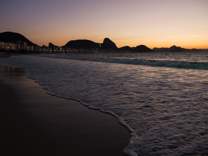 RIO DE JANEIRO, BRAZIL - JUNE 09: A general view of the Copacabana beach as the sun rises and the waves roll onto the sand prior to the 2014 FIFA World Cup on June 9, 2014 in Rio de Janeiro, Brazil. (Photo by Dean Mouhtaropoulos/Getty Images)