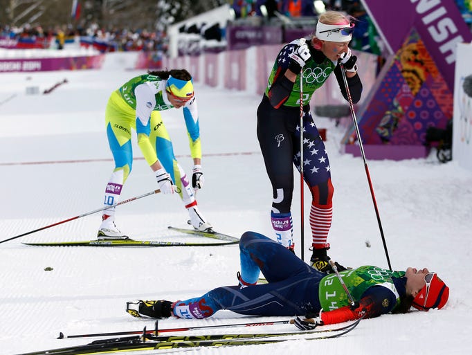 Kikkan Randall (USA, center), Julia Ivanova (RUS, bottom) and Kitja Visnar (SLO, left) react after the ladies' cross country skiing team sprint classic.