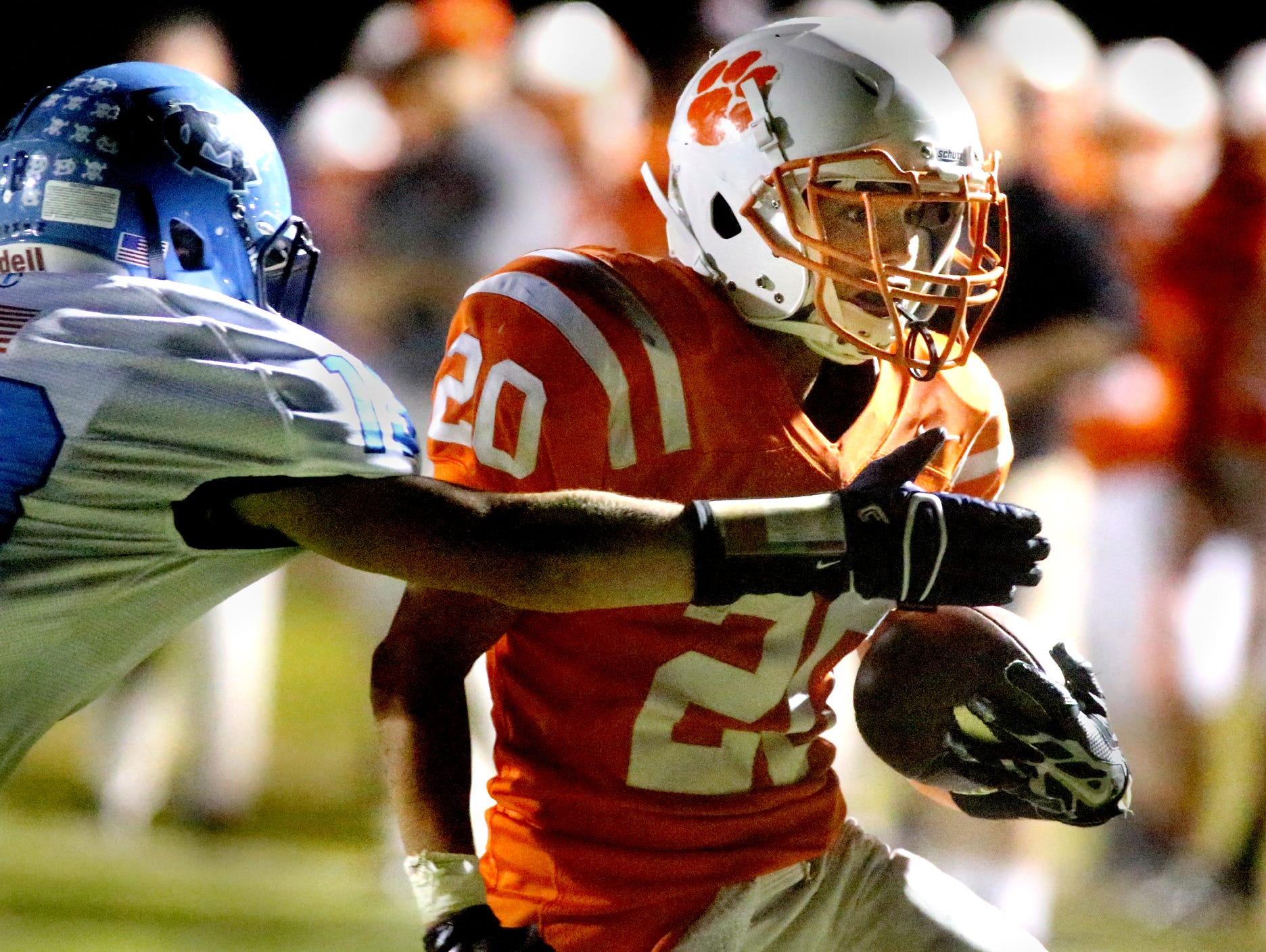 MTCS's Griffin Harper runs the ball in for a touchdown as Moore County's Mason Henshaw tries to tackle Harper during the game at MTCS, on Friday, Oct. 3, 2014.