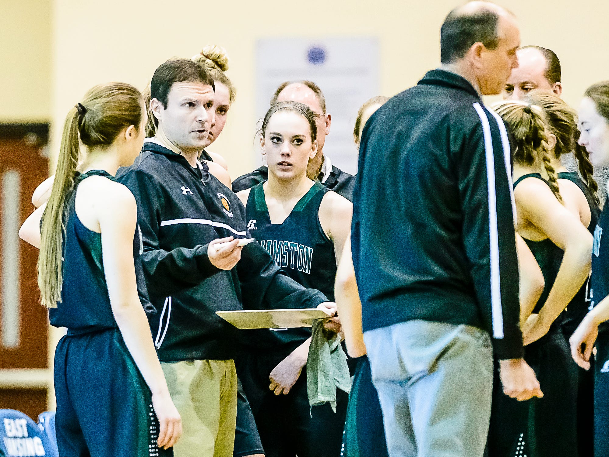 Williamston coach Pete Cool ,left, speaks to his team in a timeout during a game last month. The Williamston girls basketball program has had a consistent amount of success under Cool over the last several seasons.