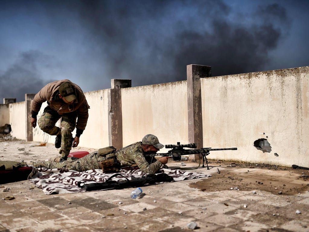 A sniper fires during a clash with Islamic State fighters in Mosul as part of an operation to retake the western parts of the city.\u000aIraqi forces attacked four jihadist-held areas in Mosul, the latest push in a battle for the city's west that has