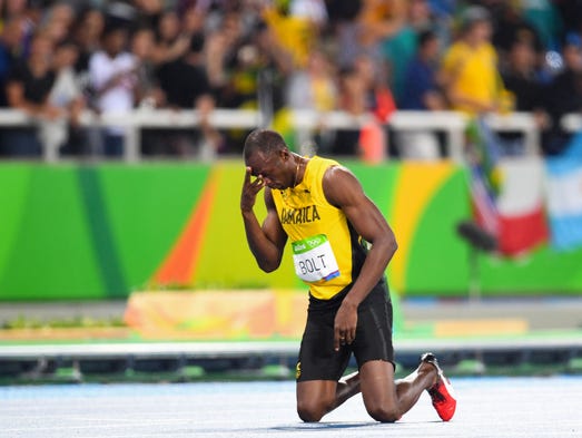 Usain Bolt (JAM) reacts as he wins gold in the men’s