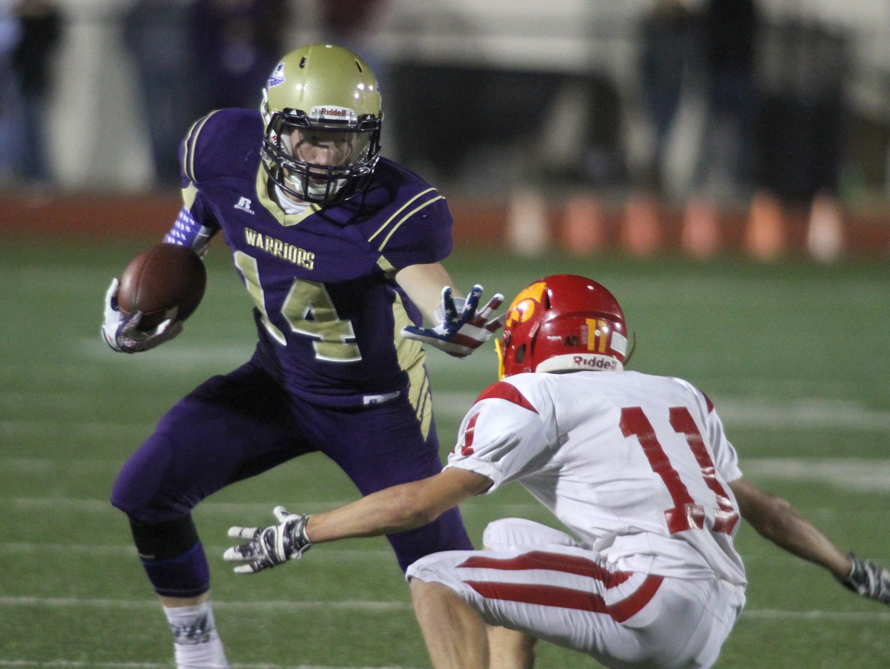 Norwalk senior Tyler Schamel tries to avoid Carlisle junior Dallas Wright. Norwalk hosted Carlisle in their Homecoming game Sept. 11, winning 23-16 with a touchdown in the final minute.