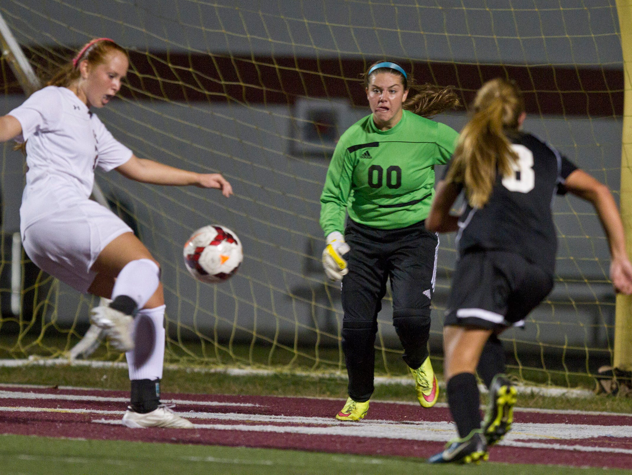 Toms River East goal keep Jordyn Ferone defends as Toms River South's Katie Hammack puts a shot on goal. Toms River East vs Toms River South soccer. Toms River, NJ Tuesday, October 13, 2015 @dhoodhood