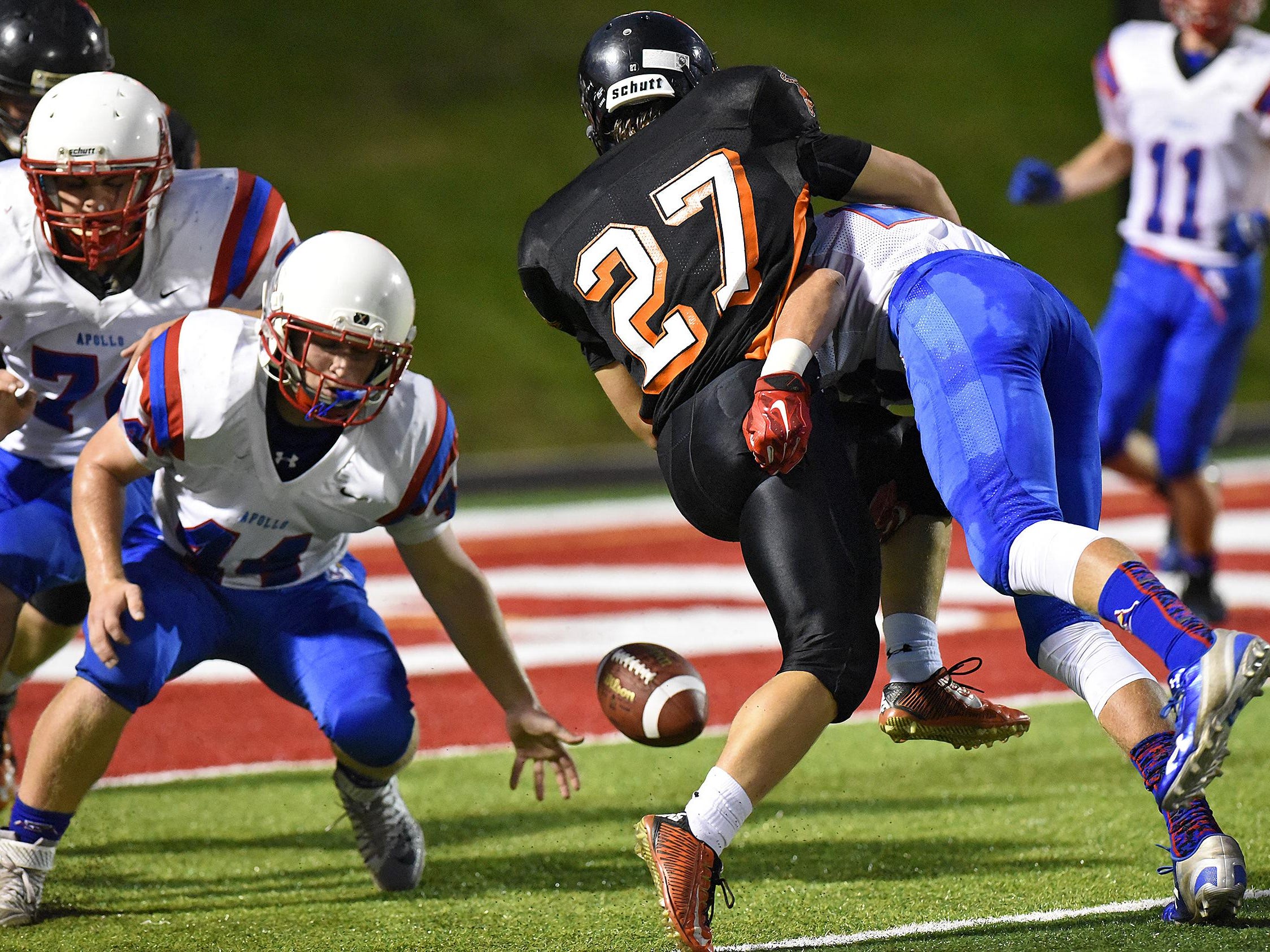 Players concentrate on a loose ball near the goal line during the first half of Friday's game at Husky Stadium in St. Cloud.
