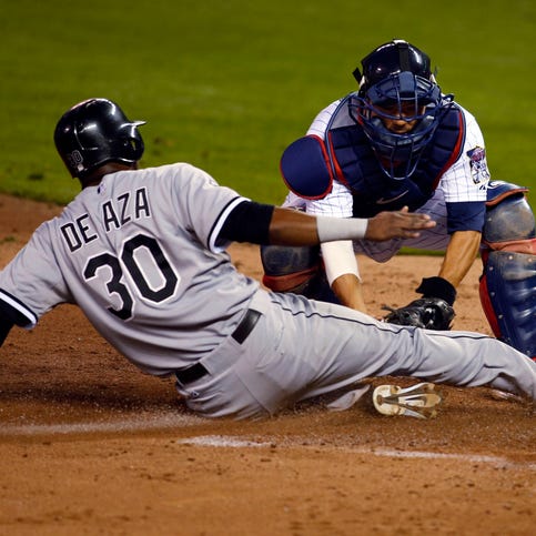 Jul 24, 2014; Minneapolis, MN, USA; Minnesota Twins catcher Kurt Suzuki (8) tags out Chicago White Sox left fielder Alejandro De Aza (30) on a fielders choice in the 6th inning at Target Field. Mandatory Credit: Bruce Kluckhohn-USA TODAY Sports
