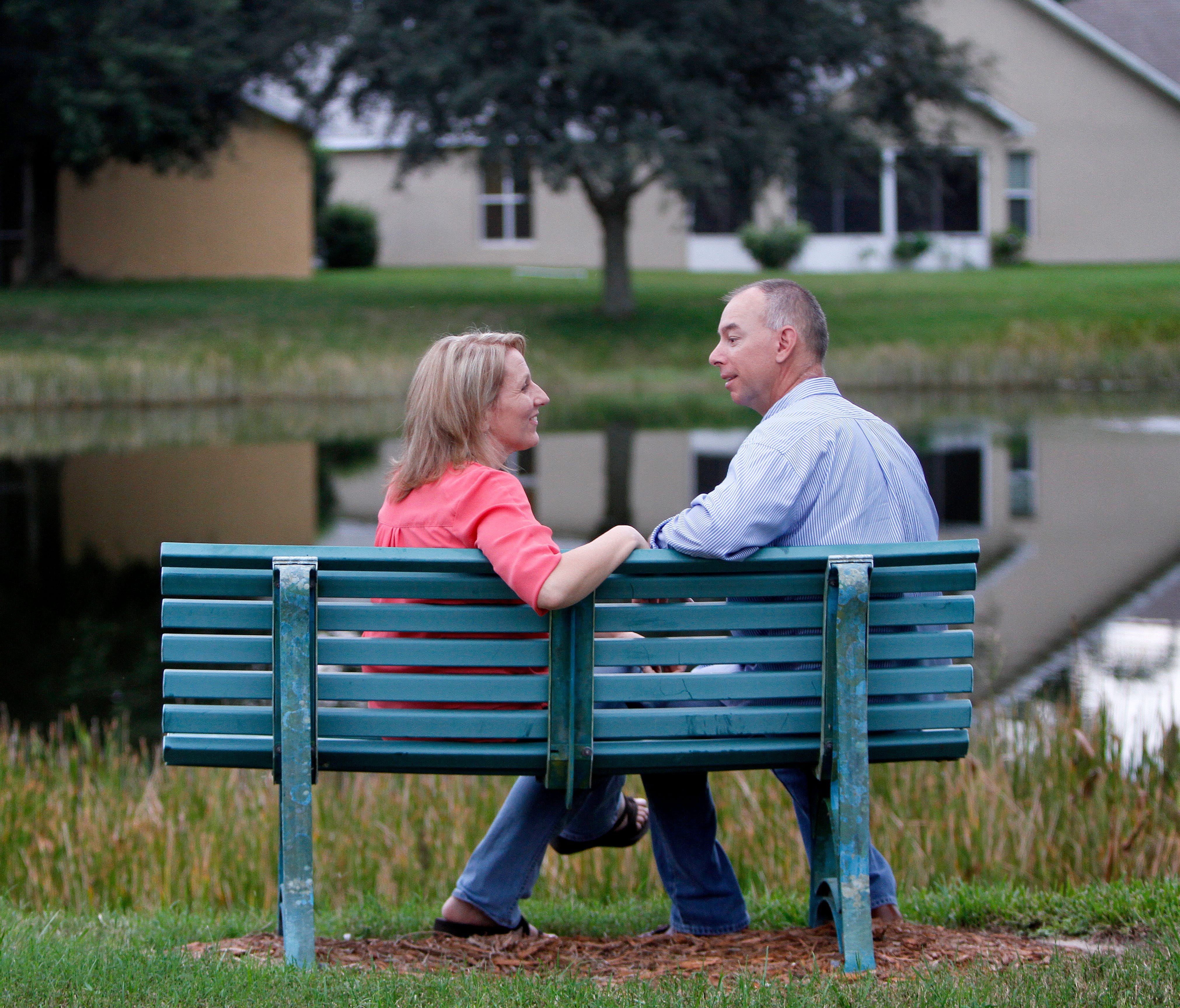 Paul Johnson and Shelly Osterhout, pictured Monday, September 28 sitting on the neighborhood bench where Paul proposed,  are inviting the public to crash their October 10 wedding reception at the Bell Tower Shops.