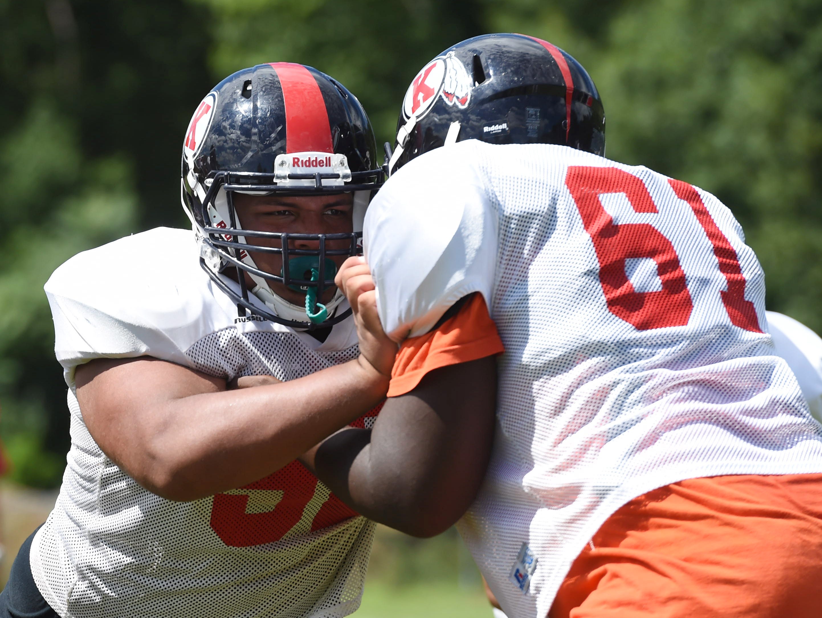 At left, John Gonzalez, a senior blocks during Wednesday's preseason practice at Roy C. Ketcham High School.