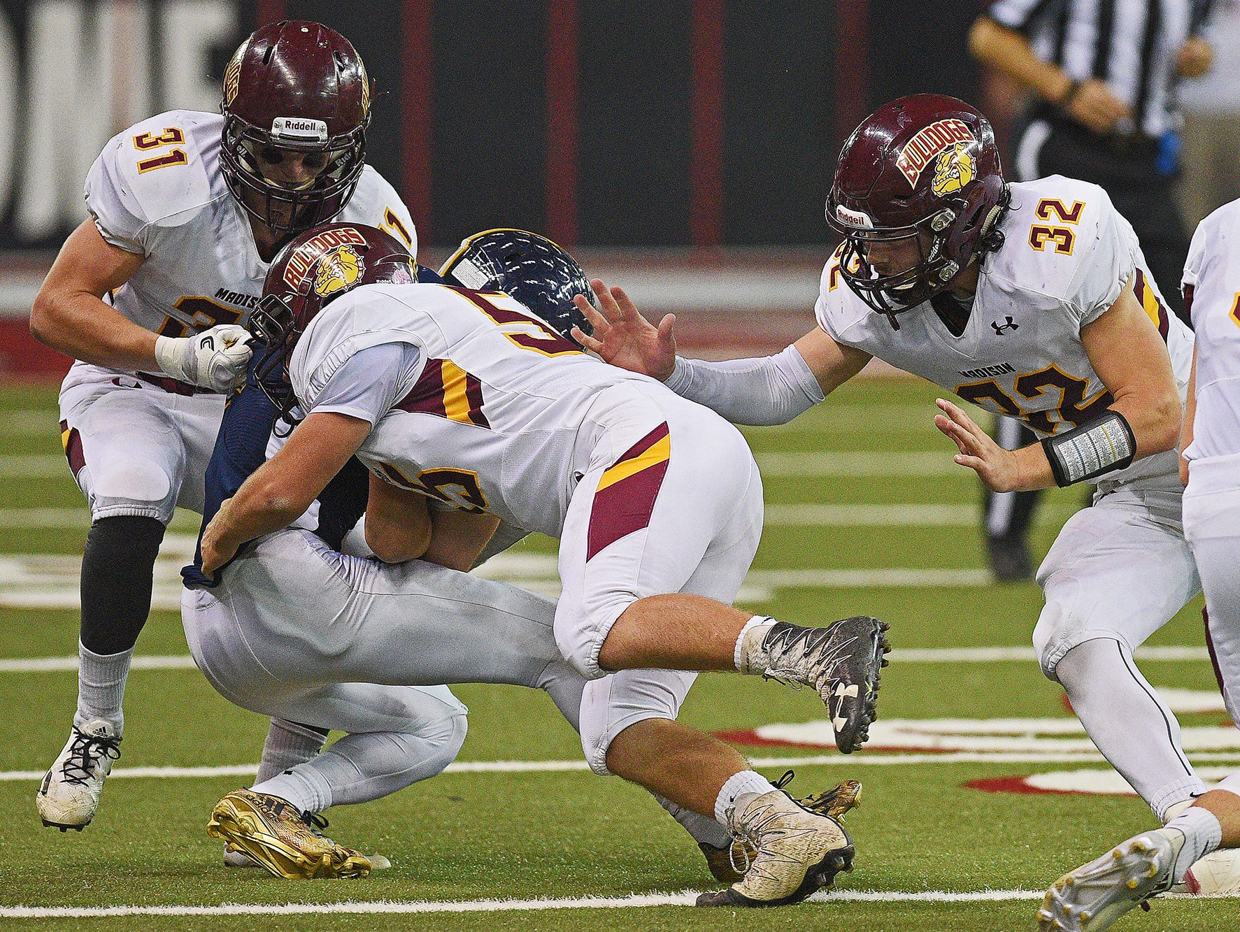 Tea Area's Carter Slykhuis (1) is brought down by Madison's Brady Nelson (55) during the 2016 South Dakota State Class 11A Football Championship game Saturday, Nov. 12, 2016, at the DakotaDome on the University of South Dakota campus in Vermillion, S.D.