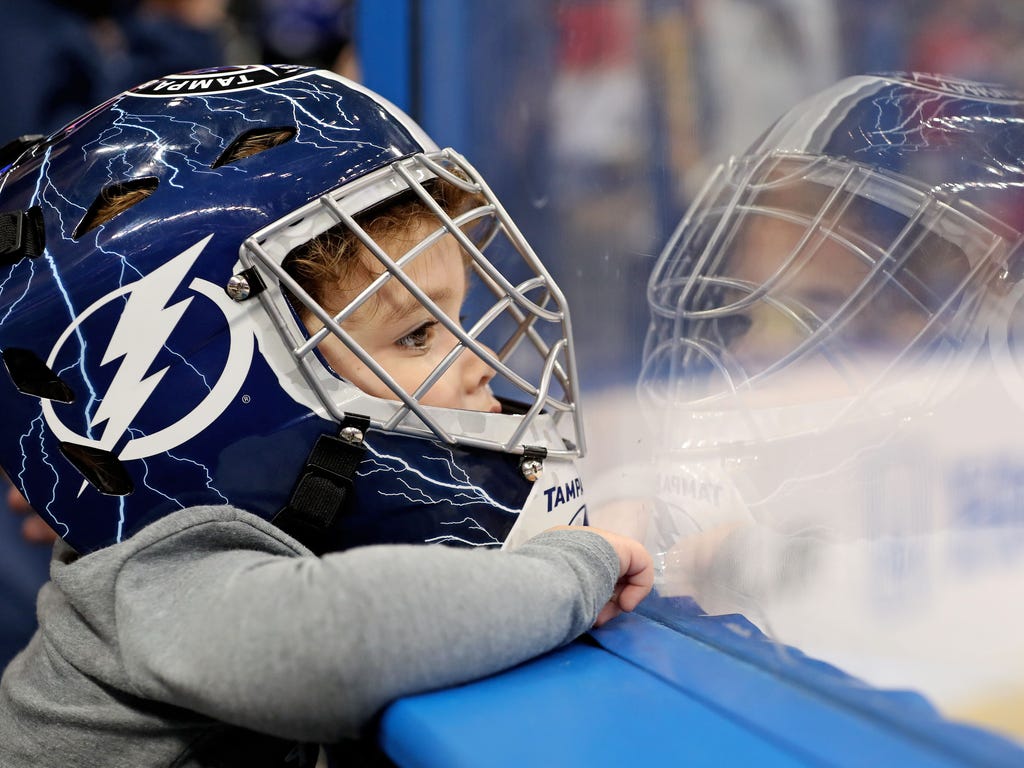 Young hockey fan Lily Koharski, 2, of watches the pregame skate before the 2018 NHL All Star Game at Amalie Arena in Tampa, Fla.