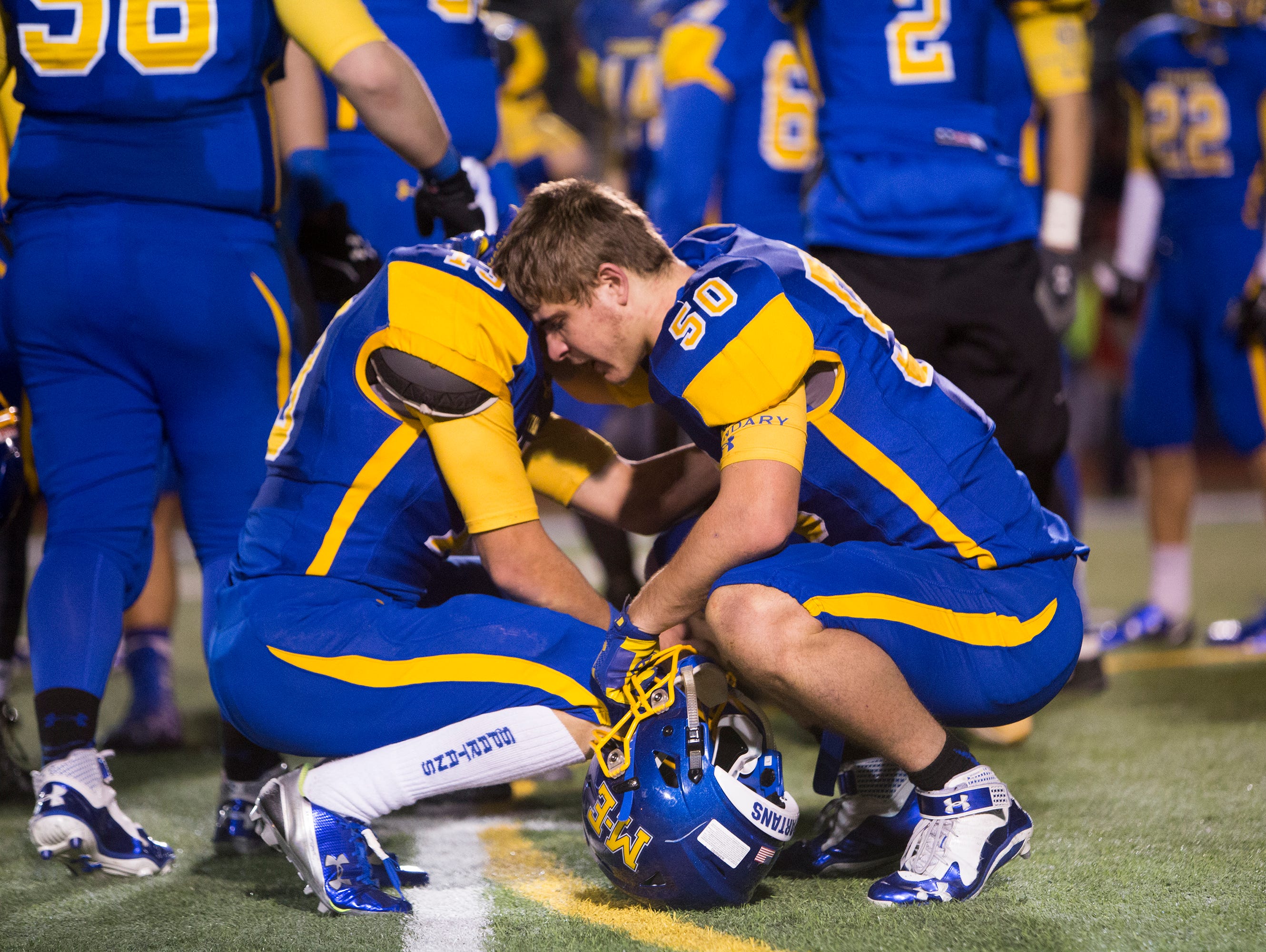 Maine-Endwell players Brady Wisniewski, right, and Micah Miller embrace after the Spartans lost 43-26 to South Park in the Class A state playoff's on Friday in Syracuse.