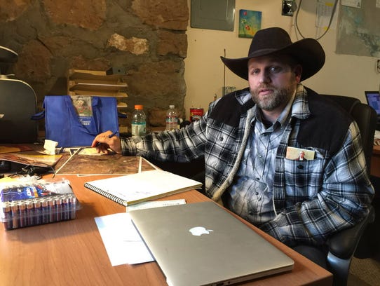 Ammon Bundy sits at a desk he's using at the Malheur
