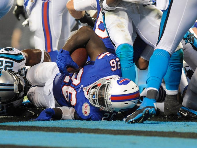 Aug 8, 2014; Charlotte, NC, USA; Buffalo Bills running back Anthony Dixon (26) drives across the goal line to score a touchdown during the first half of the game against the Carolina Panthers at Bank of America Stadium. Mandatory Credit: Sam Sharpe-USA TODAY Sports