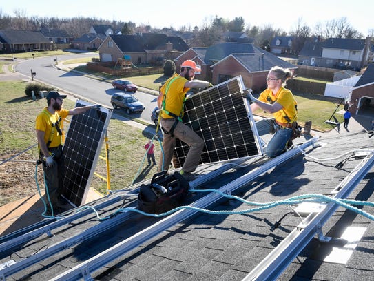 Solar panel installers (L-R) Corey Kimball, Ryan Zaricki