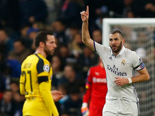 Real Madrid's Karim Benzema, right, celebrates after scoring a goal during the Champions League, Group F, soccer match between Real Madrid and Borussia Dortmund at the Santiago Bernabeu stadium in Madrid, Spain, Wednesday, Dec. 7, 2016. (AP Photo/Daniel Ochoa de Olza)