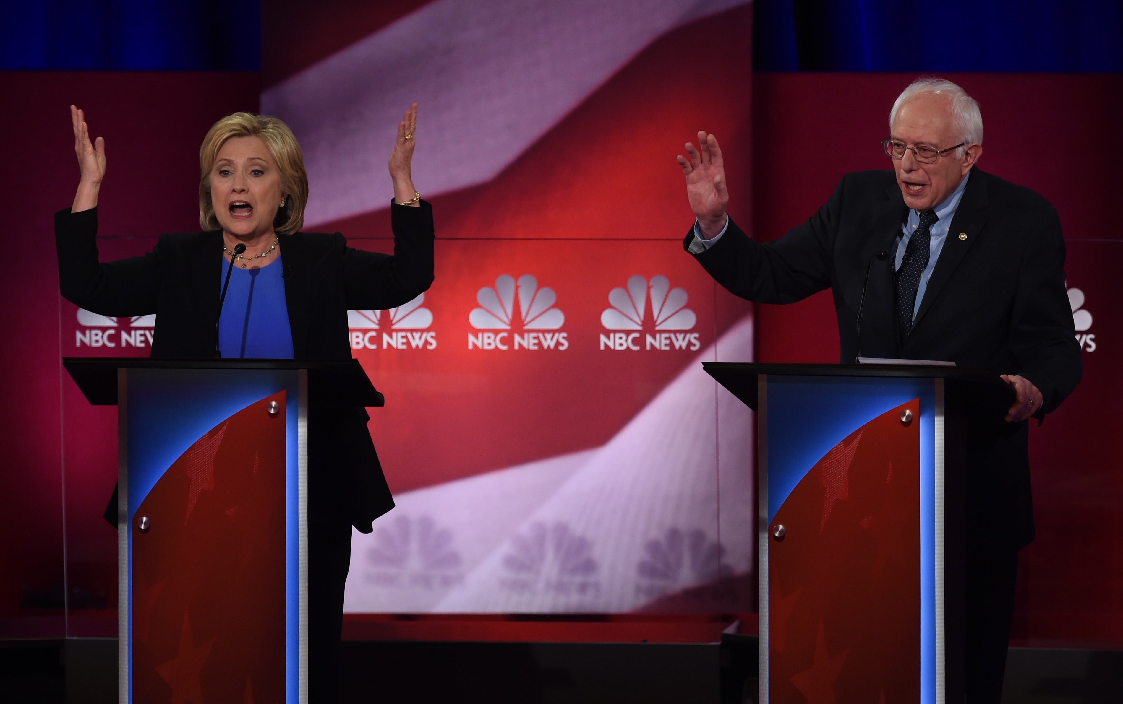 Hillary Clinton and Bernie Sanders participate in the
