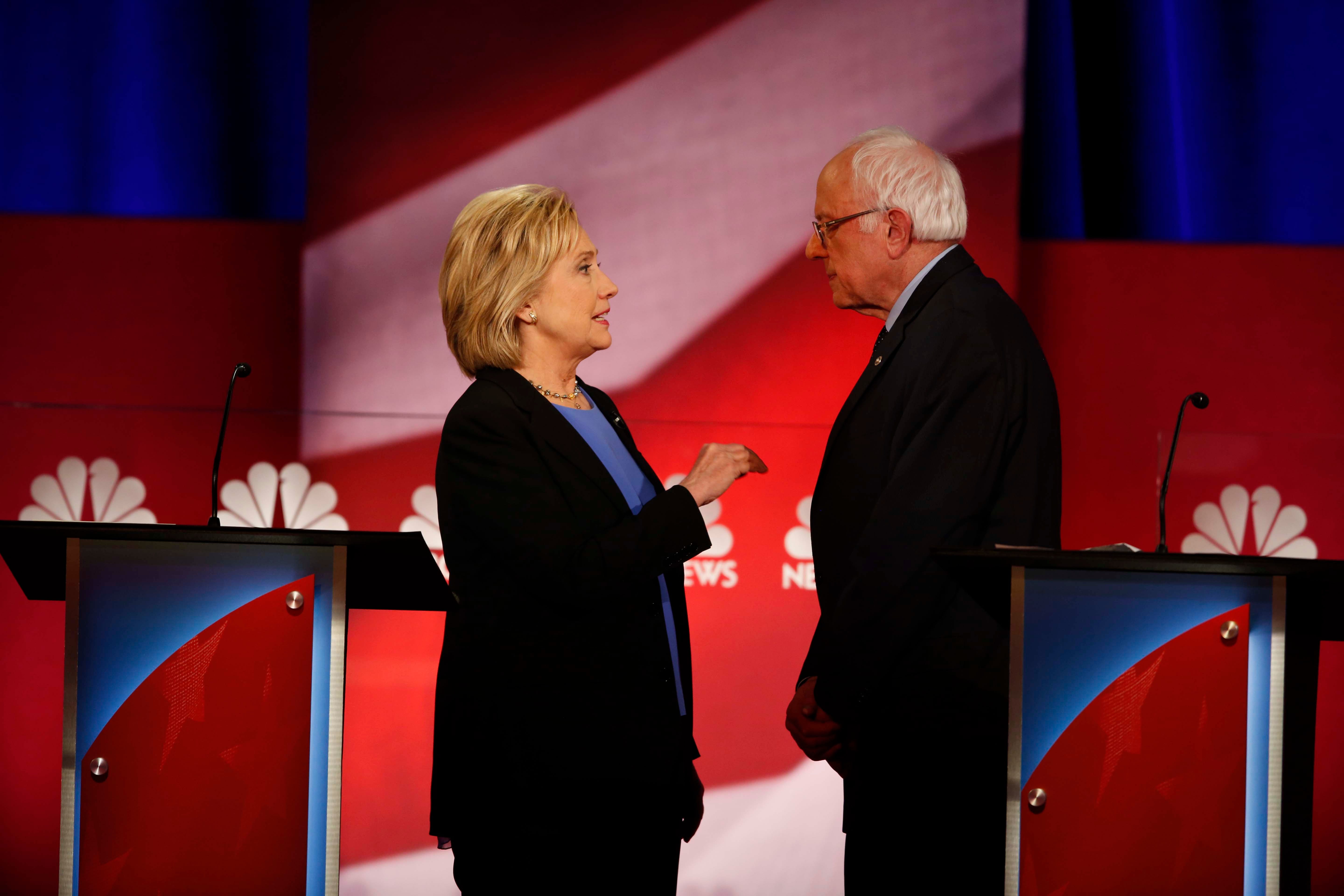 Hillary Clinton and Bernie Sanders speak during a break