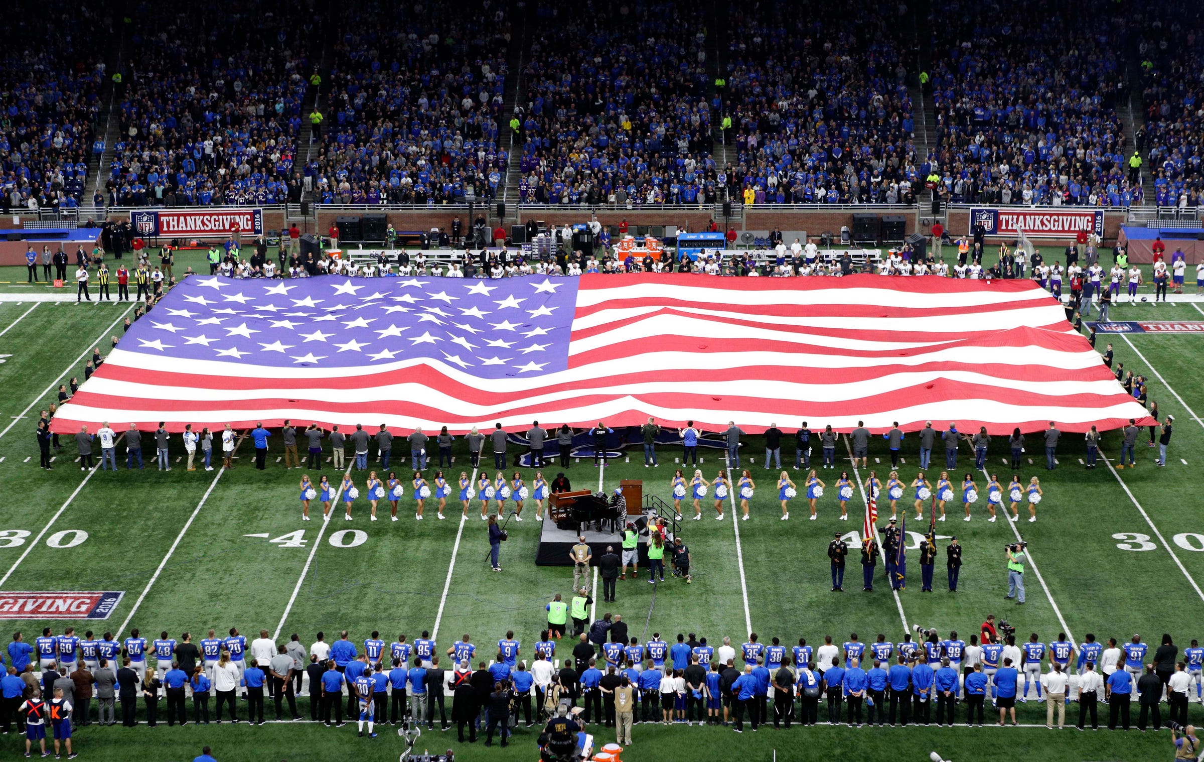 Detroit Lions players lock arms, some take knee during national anthem