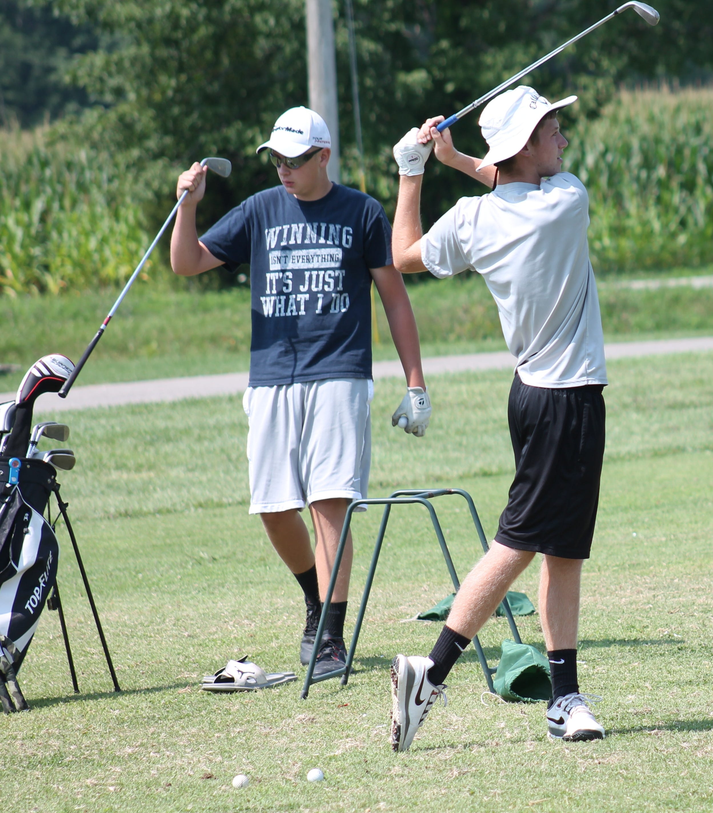 Bethel-Tate juniors Mitchell McElfresh (swinging) and Blake Combs get some work in on the range at Friendly Meadows Aug. 1.