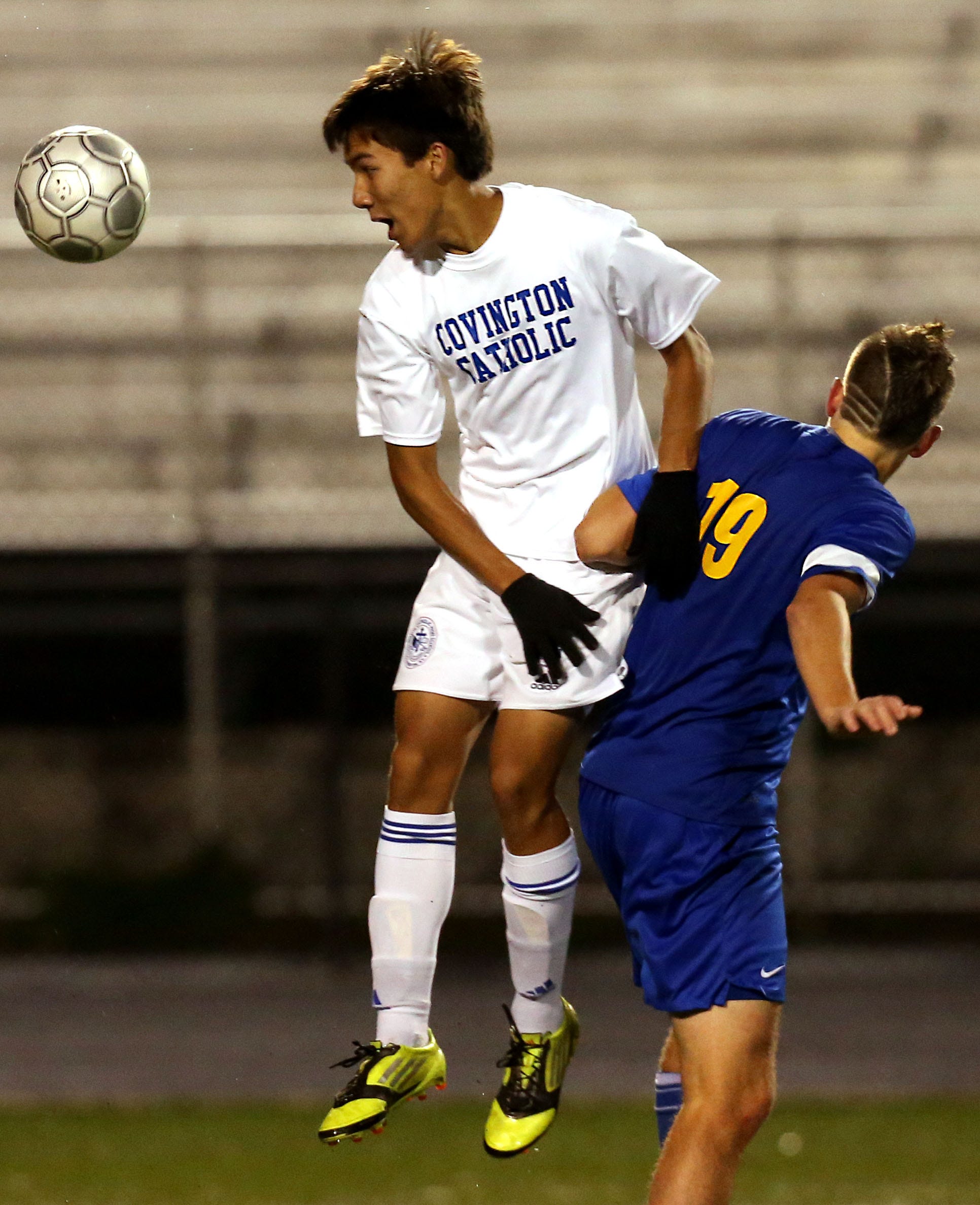Covington Catholic’s Joe Schuh (4) heads the ball against Newport Central Catholic’s Noah Connolly (19) in a soccer game at Ryle High School Oct. 24, 2013. Newport Central Catholic won 1-0 in overtime.