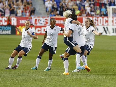 Jun 20, 2013; Harrison, NJ, USA; USA teammates celebrate with forward Abby Wambach (20) after she scored a goal to become the women's all time leading scorer during the first half against the Korea Republic at Red Bulls Arena