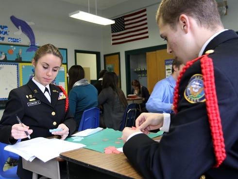 NJROTC and MAST students Jessica Casamassima, 17,  and Ryan Jordan, 17, complete a predator-prey simulation activity in their environmental science class at St. Joseph's Elementary School in Keyport, N.J. on Nov. 20, 2012. The school was the temporar