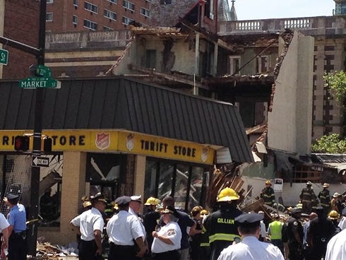Emergency personnel respond to a building collapse in downtown Philadelphia, where the city fire commissioner says as many as eight to 10 people are believed trapped in the rubble, Wednesday, June 5, 2013. (AP Photo/Jacqueline Larma) ORG XMIT: NY133