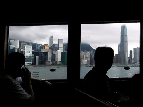 Passengers look out through the window in a ferry in Hong Kong Tuesday, June 11, 2013.