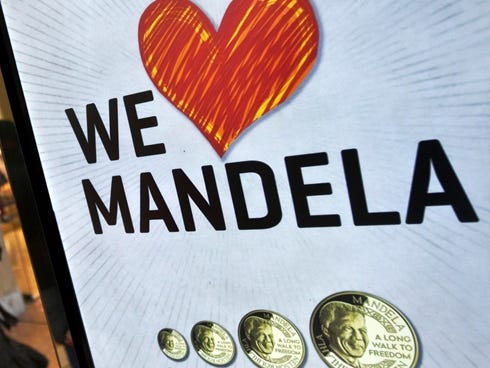 An ad is seen for a shop that sells commemorative coins with the face of Nelson Mandela in the Sandton City shopping center in Johannesburg, South Africa, on June 11, 2013.