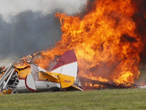 Flames erupt from a plane after it crashed at the Vectren Air Show at the airport on June 22 in Dayton, Ohio. The crash killed the pilot and stunt walker.