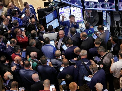 Traders gather on the floor of the New York Stock Exchange on June 21, 2013.