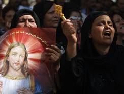 Egyptian Coptic Christians protest attacks on Christians and churches, in front of the state television building in Cairo.