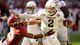 Manziel (2) stiff arms Alabama defensive back Deion Belue.
